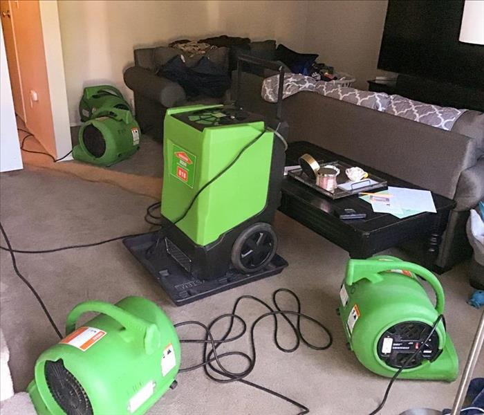 Air movers set up on the floor of a bedroom in a Kennewick home that experienced water damage.