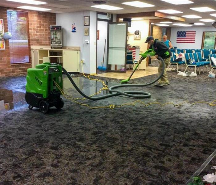 A specialist is removing a flood in a business