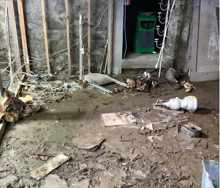 room damaged by flood, floor covered with mud
